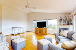 a living room with a couch and a tv at La Cana Street Leisure - Main Home & In-Law suite in Coupeville
