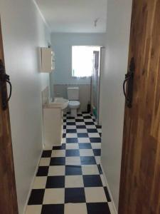 een badkamer met een zwart-wit geruite vloer bij Bribie Island. Home away from home with Kids Zone in Bellara