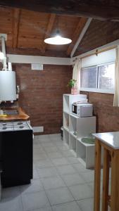 a kitchen with a stove and some boxes in it at Cabaña Rayen in Esquel