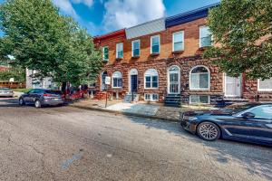 two cars parked in front of a brick building at Brixton Manor in Baltimore