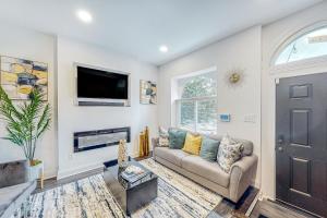 a living room with a couch and a tv at Brixton Manor in Baltimore