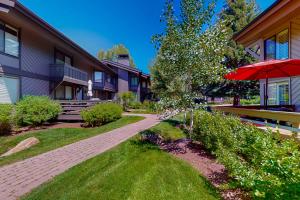 a walkway in front of a house with an umbrella at Villager Retreat in Sun Valley