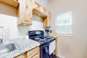 a kitchen with a stove and a sink at Addies Nest in Sevierville