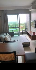 a bedroom with a large bed and a large window at Salinas Exclusive Resort in Salinópolis