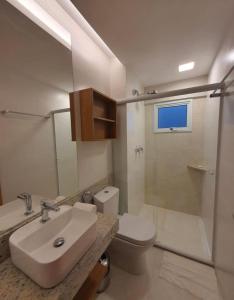 a bathroom with a sink and a toilet and a shower at Salinas Exclusive Resort in Salinópolis
