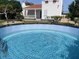 a large blue swimming pool in front of a house at Spacious holiday home in almeria near beach in Almería
