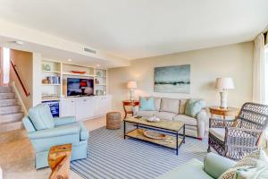 a living room with a couch and a table at Captains Court 1019 in Fernandina Beach