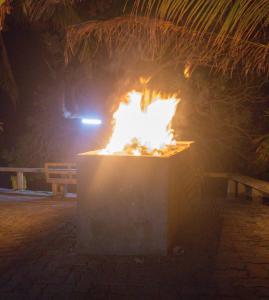 a fire pit at night with a car in the background at Silver County Hotel, Fuvahmulah - Maldives in Fuvahmulah