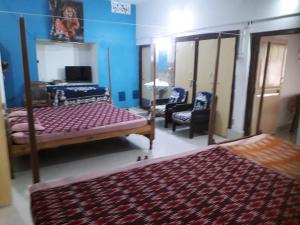Letto o letti in una camera di Sudha Kutir Puri