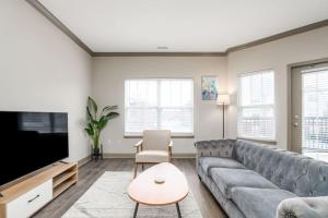 a living room with a couch and a flat screen tv at Affordable 1BD Keystone in Indianapolis