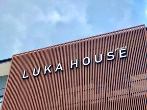 a building with the words luza house on it at Luka House in Lam Luk Ka
