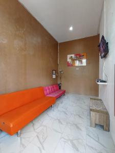 a living room with a couch and a table at Villa Lilly in Batu