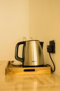 a coffee pot sitting on top of a counter at Silver County Hotel, Fuvahmulah - Maldives in Fuvahmulah