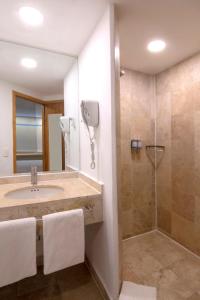 a bathroom with a sink and a shower at One Coatzacoalcos Forum in Coatzacoalcos