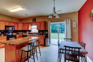 a kitchen with red cabinets and a table with chairs at Travelers Cove in Cleveland