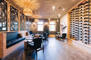 a wine tasting room with chairs and wine racks at Kwa'lilas Hotel in Port Hardy