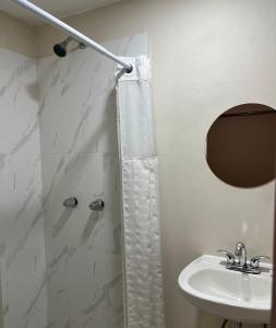 a bathroom with a shower and a sink at HOTEL VILLAGRAN in Tijuana