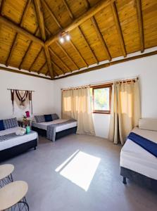 a room with two beds and a table and chairs at Casa Odara Trancoso in Trancoso +88 photos