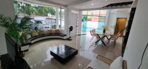 a living room with a couch and a table at Casaquinta Con Piscina in Villeta