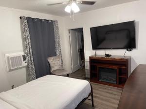 a bedroom with a bed and a flat screen tv at Americas Best Value Inn Royal Carriage in Jamestown