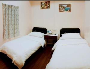Postel nebo postele na pokoji v ubytování Sipadan Crystal Haven Inn