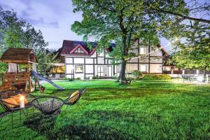 a large house with a playground in the yard at Apartment in Leba with a garden in Łeba