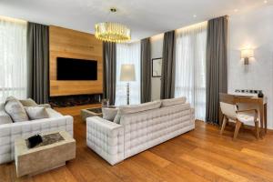 a living room with a white couch and a table at Parklane, a Luxury Collection Resort & Spa, Limassol in Limassol