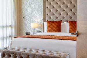 a bedroom with a large bed with a large headboard at Parklane, a Luxury Collection Resort & Spa, Limassol in Limassol