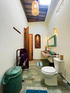 a bathroom with a toilet and a sink at Uluwatu Lumbung Cottages in Uluwatu