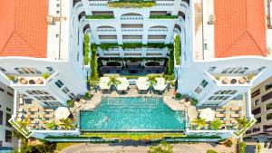 an aerial view of a building with a swimming pool at Lasenta Boutique Hotel Hoian in Hoi An