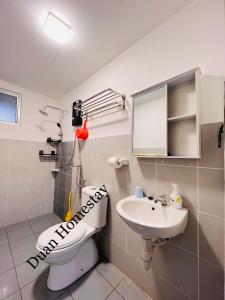 a bathroom with a toilet and a sink at Duan Homestay @ Cybersouth (Muslim shj) in Kampung Dengkil