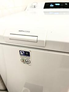 a white printer sitting on top of a appliance at Atomcity Apartman in Paks