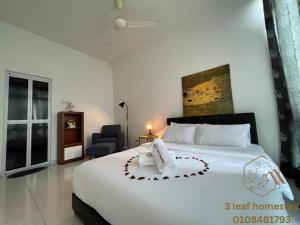a bedroom with a large white bed with a heart on it at Senai Garden Apartment near Senai Airport&JPO 