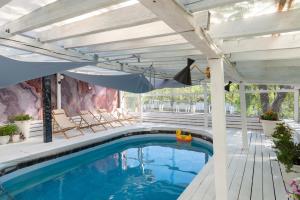 a swimming pool with a patio umbrella and a swimming pool at Inn OZZ in Karagandy