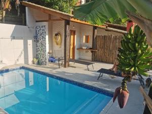 a large bunch of bananas hanging over a swimming pool at Chalé Mauá Conforto e Arte in Visconde De Maua