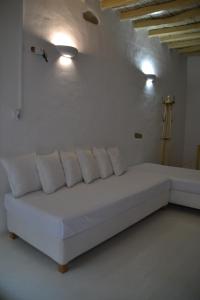 a white couch in a white room with lights at Kastro in Parikia