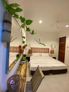 a bedroom with a bed in a room at Ocean Cottage Maldives in Thulusdhoo