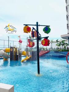 a pool with a water park with a water slide at SeaView PoolView CityView BaliResidence Video game 5minJonker in Melaka
