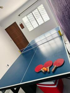 a ping pong table with red ping pong paddles on it at Hotel Congonhas 1 in Sao Paulo