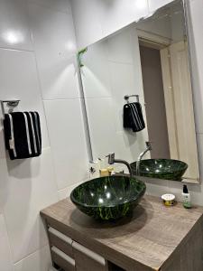 a bathroom with a large green sink and a mirror at Hotel Congonhas 1 in Sao Paulo