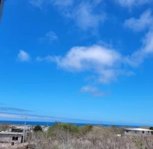 a view of the ocean and a blue sky with clouds at CASA FRAGATA in Puerto Baquerizo Moreno