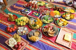 a table topped with lots of different types of food at SRI SANKARA VILLAS -- Aditya Heritage in Kumbakonam