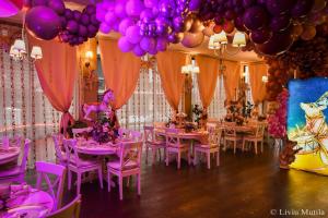 a room with pink tables and chairs and balloons at Princess Butique in Poiana Brasov