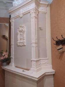 a white display case with a antler on a wall at Julia Lacplesa Apartments in Riga