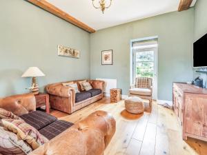 a living room with a couch and a bed at Hillcrest, Blythburgh in Blythburgh