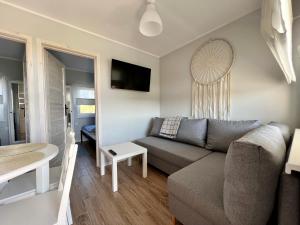 a living room with a couch and a table at Domki Maju Maj in Darłowo