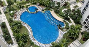 an overhead view of a swimming pool at a resort at Cozy Beach Escape: 2BR Muji Gem in Johor Bahru