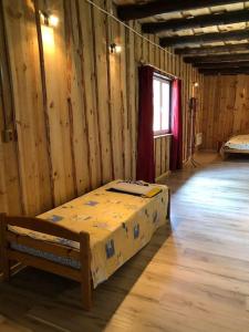 - une chambre avec un lit dans une pièce dotée de murs en bois dans l'établissement The Barn, à Pärnu