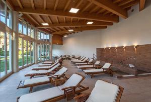 a row of chairs in a large room with windows at Hotel Terme Patria in Abano Terme