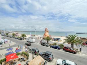 a busy street with cars parked on the beach at The Skipper's House in Weymouth